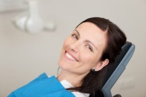 21246823 - portrait of mid adult female patient smiling in dentistry on Huntingdon Valley Dental Arts